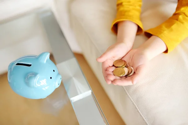Little boy putting coin into piggy bank. — Stock Photo, Image