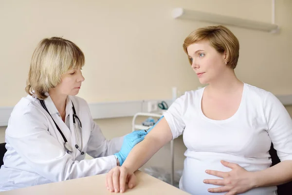 Médecin ou ambulancier fait la vaccination d'une femme enceinte. Assurance maladie maternité. Médecin de famille pour la gestation . — Photo