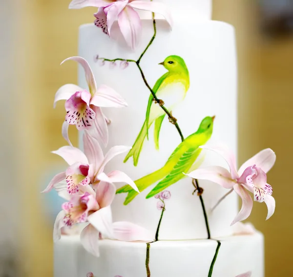 Traditional anniversary/wedding multi-layer cake. Beautiful delicious sweet dessert decorated with flowers
