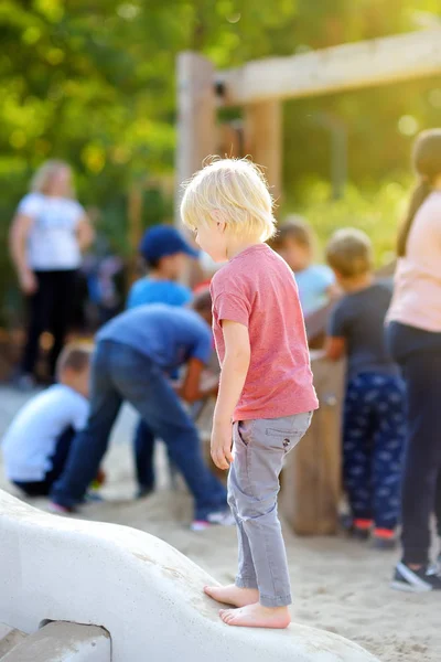 Petit garçon s'amusant sur l'aire de jeux extérieure du parc public à la journée ensoleillée d'été . — Photo