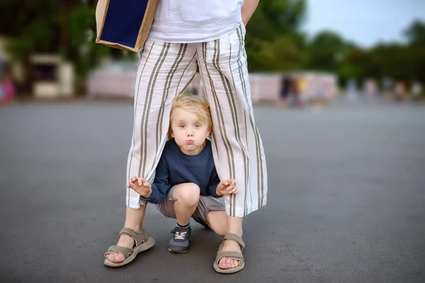 Malý hravý chlapec se bavil při chůzi s matkou. Dětský žerty kolem teplého letního večera ve veřejném parku. — Stock fotografie