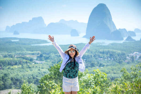 cheering woman hiker open arms  at Phang Nga Bay from Samed Nang Chee, Thailand