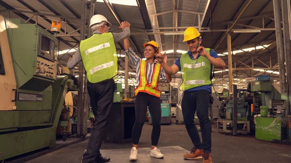 Happy Team Of Engineers dancing In Factory