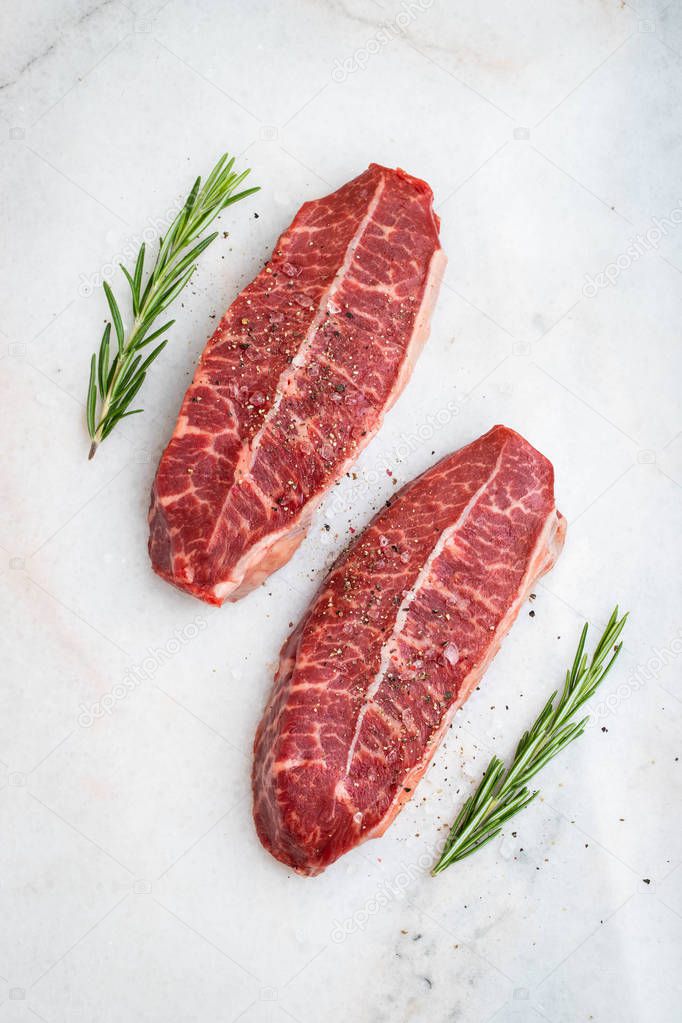 Raw fresh meat Top Blade steaks on light background. top view