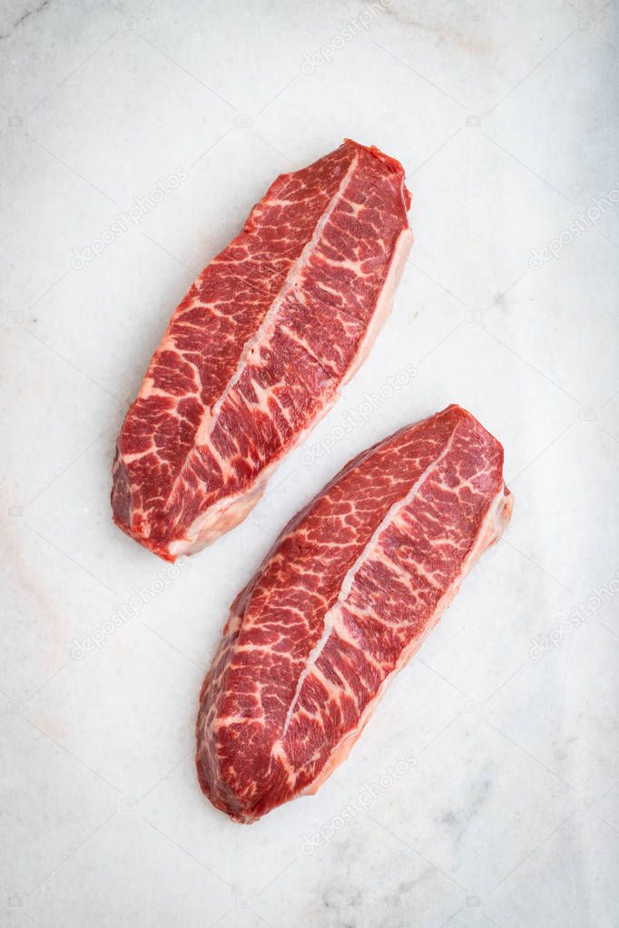 Raw fresh meat Top Blade steaks on light background. top view