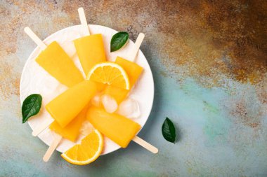 Mavi bacground suyu ile turuncu çubuklu dondurmayı. Buz açılır, kopya alanı düz yatıyordu, en iyi manzaralı.