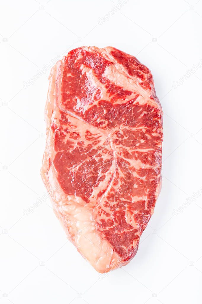 Raw striploin beef steak isolated against white. top view.