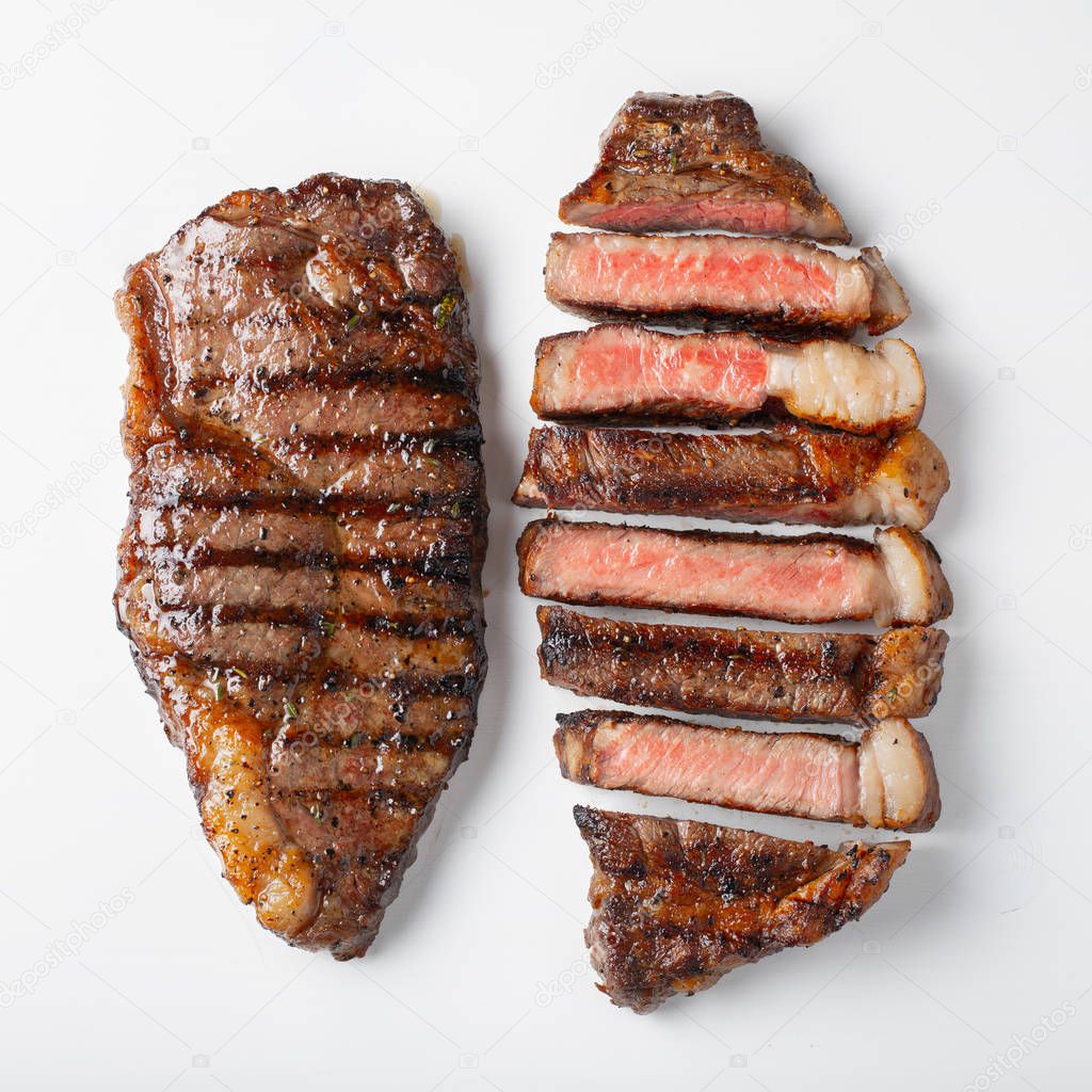 Two grilled marbled beef steaks striploin isolated on white background, top view.