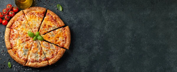 Fesleğen, domates ve karanlık bir beton masaya zeytin yağı ile lezzetli İtalyan pizza dört peynir. Üstten görünüm kopya alanı ile. Düz yatıyordu. afiş