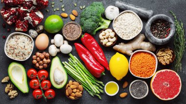 Sağlıklı gıda seçimi yeme temiz: meyve, sebze, tohum, superfood, Mısır gevreği, yaprak sebze yatıyordu düz siyah beton zemin üzerine