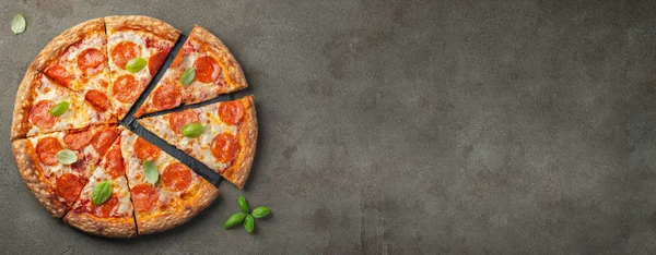 Pizza pepperoni savoureuse au basilic sur table en béton — Photo