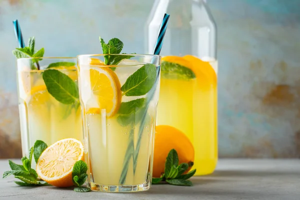 İki bardak limonata ya da naneli mojito kokteyli soğuk, ferahlatıcı içecek ya da buzlu, mavi arka planda buzlu içecek. Boşluğu kopyala