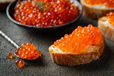 Koyu beton arka plan üzerinde kırmızı havyar ile Lezzetli Sandviçler