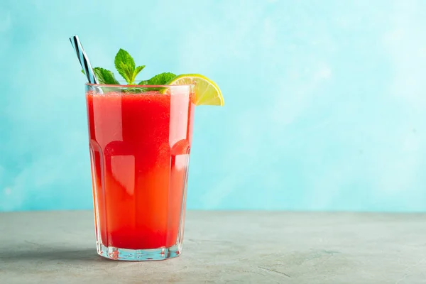 Watermeloen slushie met limoen en Mint, zomer verfrissend drankje in hoge glazen op een licht blauwe achtergrond. Zoete koude smoothie met Kopieer ruimte — Stockfoto