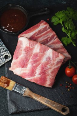 Çiğ et. Sırtından çiğ domuz kaburgası ve siyah bir arka planda et. arkaplan resmi, boşluk metni kopyala