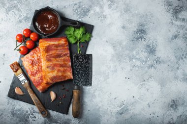 Barbekü, çiğ domuz pirzolası ve barbekü sosu hazır. Siyah arka plan. Üst görünüm.