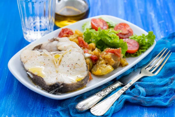 Boiled fish with salad on white dish — Stock Photo, Image