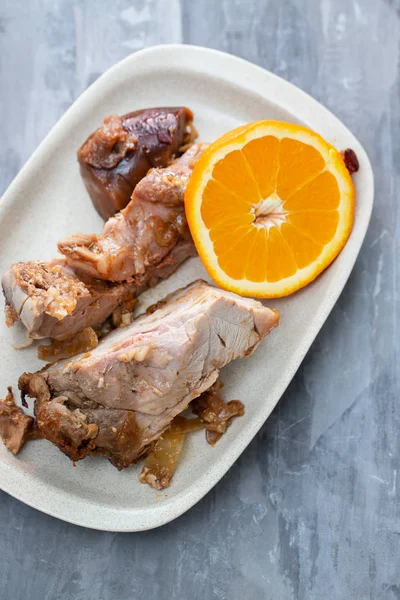 Carne assada com laranja no prato branco — Fotografia de Stock