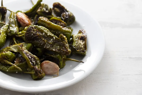 Typical spanish food grilled green pepper with salt on dish — Stock Photo, Image