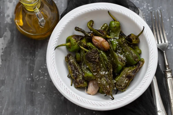 Typical spanish food grilled green pepper with salt on dish — Stock Photo, Image