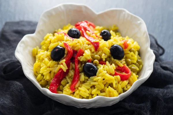 Rice with vegetables and black olives in beautiful dish — Stock Photo, Image