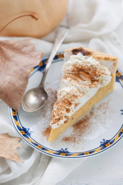 Pumpkin cake with cream and cinnamon on dish — Stock Photo, Image