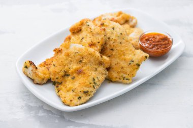 seramik backgro beyaz çanak üzerinde sos ile kızarmış tavuk göğsü