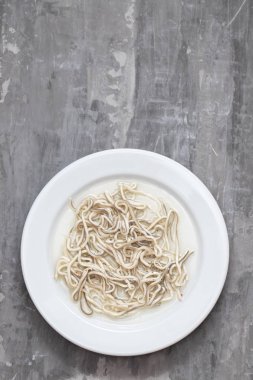 Traditional Spanish food. Gulas with oil on white plate.  clipart