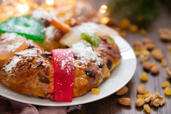 Typical portuguese fruit cake Bolo rei on wooden background — Stock Photo, Image