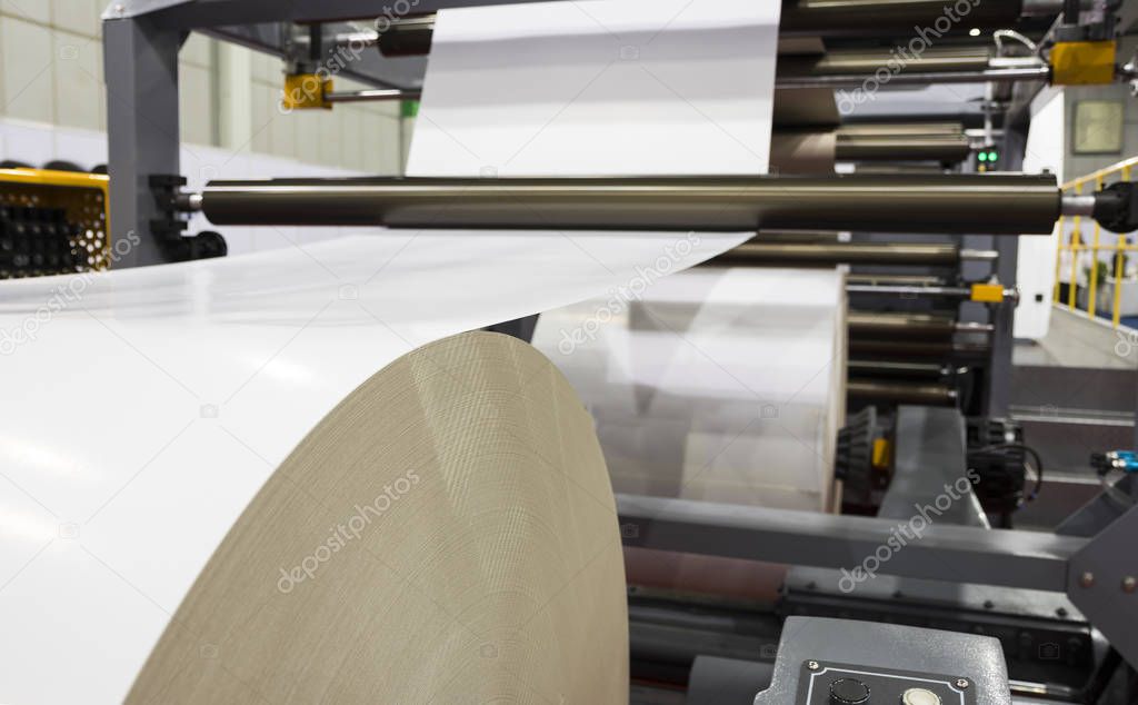 roll of white paper in modern paper cutting machine