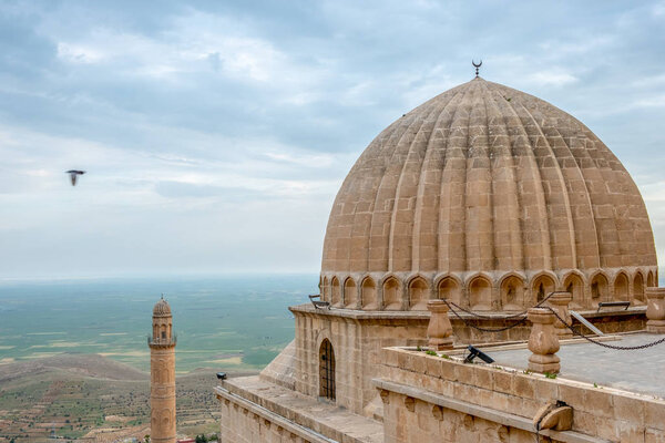 Minaret of the Great Mosque known also as Ulu Cami with mesopotamian plain in the background, Mardin, Turkey.