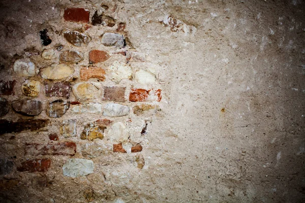 Aged wall background with stones and bricks