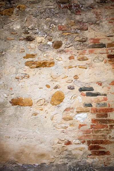 Aged wall background with stones and bricks