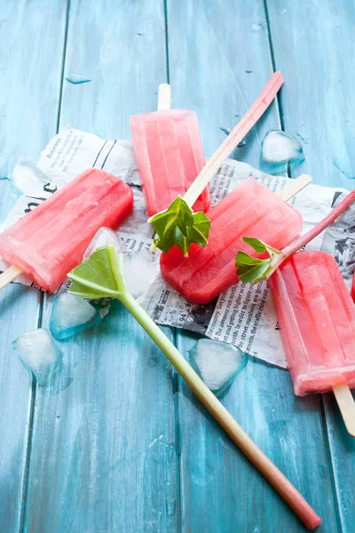 Refreshing Rhubarb Popsicles Blue Wooden Background Newspaper Article — Stock Photo, Image