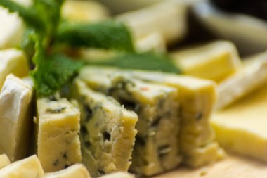 Tahtadaki farklı peynirler, peynir tahtası, lezzetli atıştırmalıklar, sağlıklı ve özel yemekler, peynir takımı.