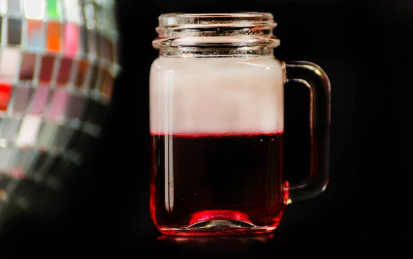 colorful drink shot on disco mirror ball background, refreshing mini drink, party night