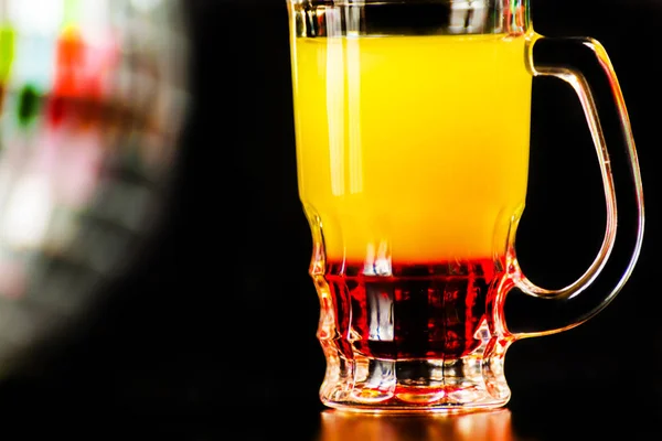 colorful drink shot on disco mirror ball background, refreshing mini drink, party night