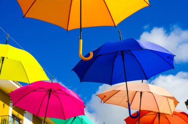 Renkli şemsiyeler kentsel sokak dekorasyon. Mavi gökyüzü, turistik, güneşli gün asılı renkli şemsiyeler