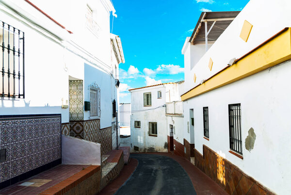 Beautiful, picturesque street, narrow road, white facades of buildings, Spanish architecture, sunny day
