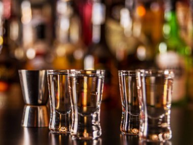 Geleneksel saf votka şişeleri, gece hayatı ile çubuğunun arka planda bardaklarda