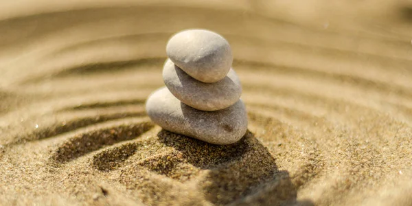 zen meditation stone in sand, concept for purity harmony and spirituality, spa wellness and yoga background, harmony