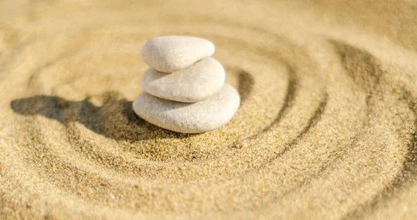 zen meditation stone in sand, concept for purity harmony and spirituality, spa wellness and yoga background, harmony
