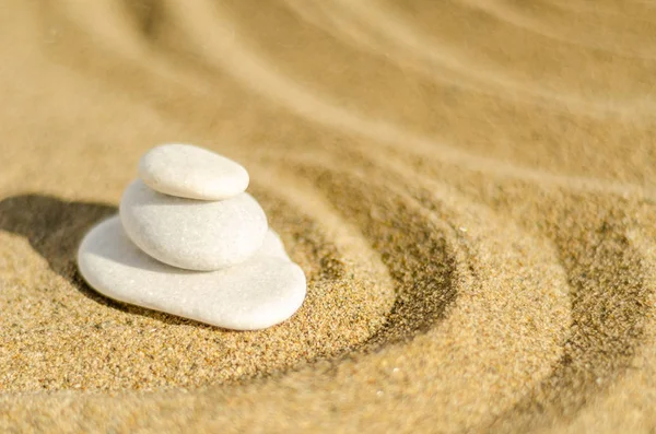 zen meditation stone in sand, concept for purity harmony and spirituality, spa wellness and yoga background, harmony