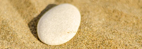 zen meditation stone in sand, concept for purity harmony and spirituality, spa wellness and yoga background, harmony