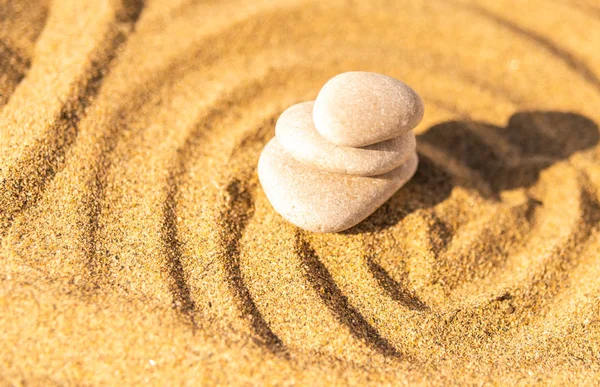 zen meditation stone in sand, concept for purity harmony and spirituality, spa wellness and yoga background, harmony