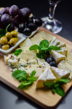Tahtadaki farklı peynirler, peynir tahtası, lezzetli atıştırmalıklar, sağlıklı ve özel yemekler, peynir takımı.