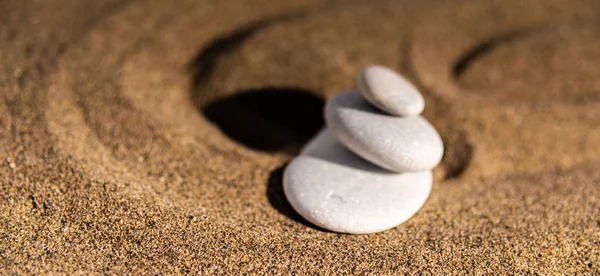 zen meditation stone in sand, concept for purity harmony and spirituality, spa wellness and yoga background, harmony