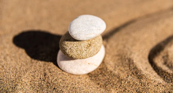 zen meditation stone in sand, concept for purity harmony and spirituality, spa wellness and yoga background, harmony