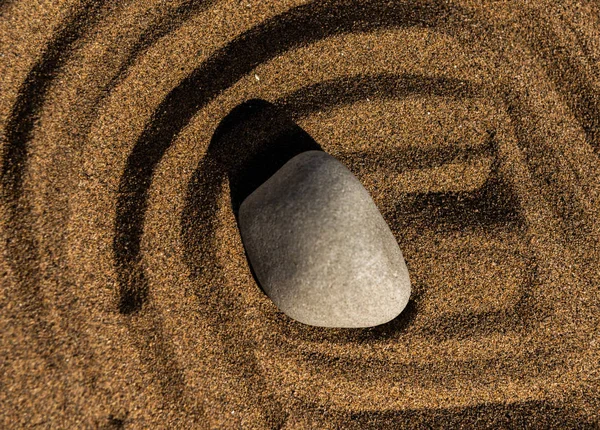 zen meditation stone in sand, concept for purity harmony and spirituality, spa wellness and yoga background, harmony