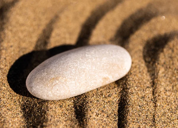 zen meditation stone in sand, concept for purity harmony and spirituality, spa wellness and yoga background, harmony